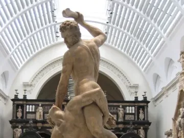 Samson Slaying a Philistine marble sculpture in a museum gallery, with one figure standing over another and raising a club.