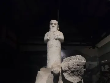 Çineköy inscription stone sculpture with a standing bearded figure and a damaged animal relief at the base