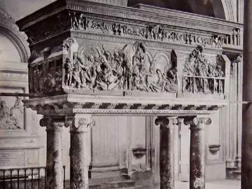 The Resurrection Pulpit by Donatello, a bronze pulpit with detailed relief scenes on four marble columns inside a church.