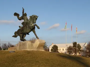 Suvorov Monument, a bronze equestrian statue of Alexander Suvorov on a stone base with flags and a building in the background.
