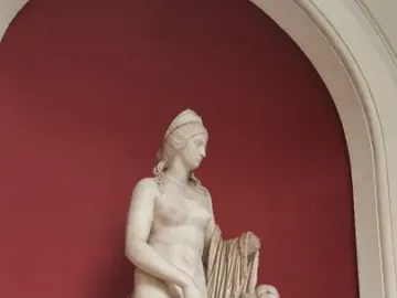Venus Felix marble statue with a standing draped female figure beside a smaller nude figure with missing arms.