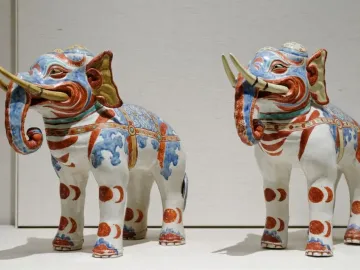 Pair of Kakiemon elephants with blue, red, and gold decorative patterns on white porcelain.