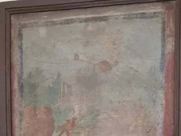 Faded fresco depicting Athena and Marsyas among rocks and sparse foliage.