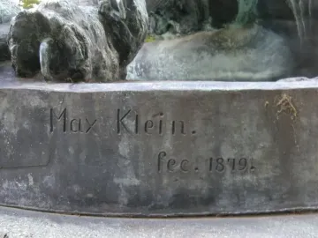 Weathered bronze base of Hercules and the Nemean Lion with the inscription \