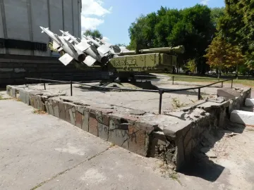 Battle of the Dnieper Diorama monument with a green military missile launcher and grey missiles on a concrete base