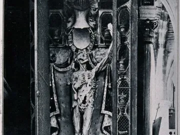 The Transi of René of Chalon, an upright skeletal figure in an ornate architectural niche with columns and draped details.