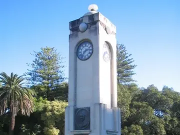 Edith Cowan Memorial stone clock tower with a bronze bust and plaque.