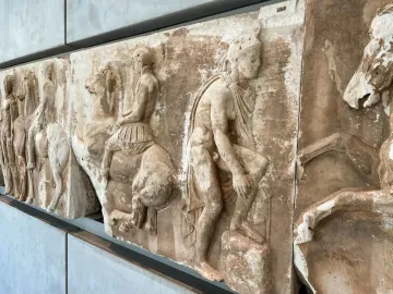 Parthenon frieze marble relief with horsemen and a draped figure