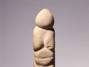 Venus of Chiozza stone figurine with a stylized standing female form and prominent breasts