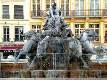 Fontaine Bartholdi fountain sculpture in Lyon with a female figure in a horse-drawn chariot and flowing water