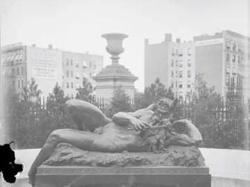 The Great God Pan bronze statue reclining and playing a pipe beside a fountain basin.