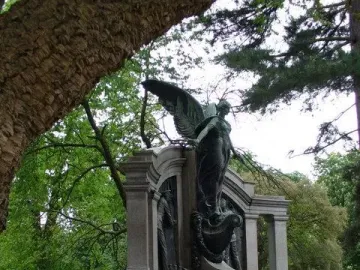 Titanic Engineers\' Memorial with a winged bronze figure and relief panels in a park.