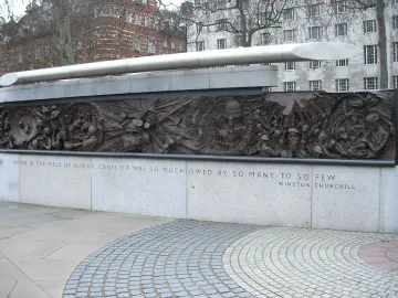 Battle of Britain Monument bronze relief panel with aircraft, pilots, and a Churchill quote on the stone base