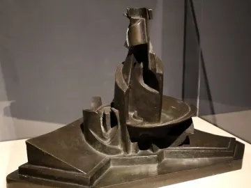 Development of a Bottle in Space, a dark bronze abstract sculpture with geometric and curving forms on a tiered base.