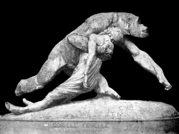 Black-and-white photograph of the sculpture Gorilla Carries a Woman, showing a gorilla striding forward with an unconscious woman draped over its back.