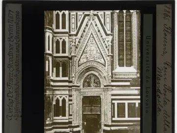 Porta della Mandorla portal on the facade of Florence Cathedral, with a carved arched doorway and ornate reliefs above it.