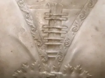 Detail of the Bust of a Young Woman showing carved foliage bands and oak leaf motifs in white marble.