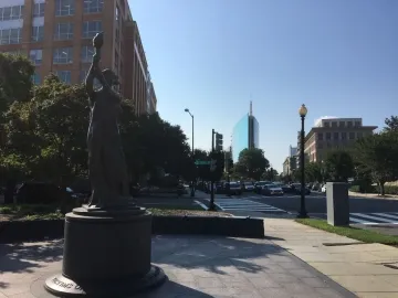 Victims of Communism Memorial statue of a robed figure holding a torch aloft.