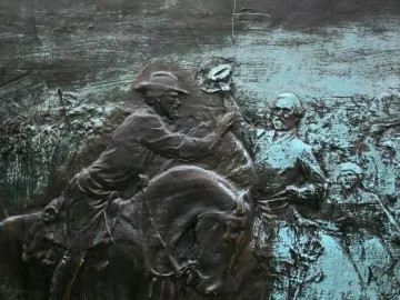 Bronze relief panel from the John Brown Gordon statue showing a mounted figure reaching toward a standing man raising his hat.