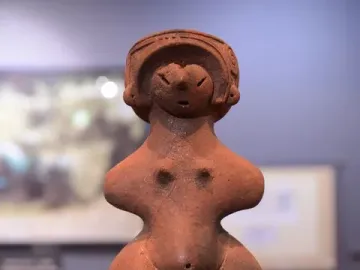 Jōmon Venus clay figurine with a patterned headdress, broad hips, and a rounded belly