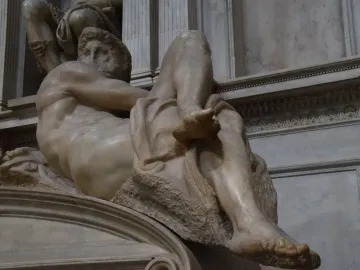 Michelangelo\'s Day, a reclining nude marble male figure in the Sagrestia Nuova.