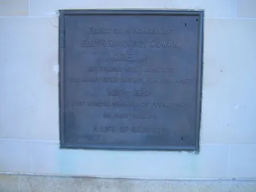 Bronze plaque on the Edith Cowan Memorial mounted on a light stone wall.