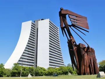 Monument to the Azoreans, a rust-colored abstract metal sculpture with human figures and a sweeping ship-like form against the sky.