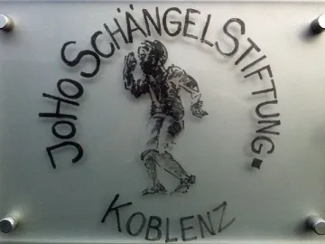 Frosted Schängel Stiftung sign in Koblenz with a boy etching and raised hand
