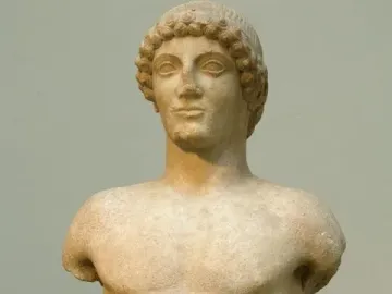 Apollo Strangford marble kouros statue with missing arms and lower legs, shown frontally on a dark base.