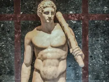 Lansdowne Heracles, a marble statue of a muscular nude male figure holding a club over his shoulder with a lion skin beside him.