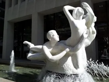 The Quest sculptural fountain with intertwined human figures and splashing water in Portland.