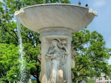 Dupont Circle Fountain with carved female figures and water flowing from its upper basin