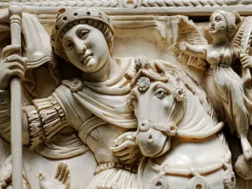 Barberini Ivory carving showing a crowned horseman with a staff and a small winged figure beside him.
