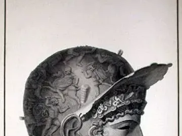 Ribchester Helmet in profile, showing a decorated face mask, elaborate curls, and a wing-like ornament at the front.