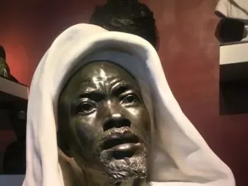 Salem, Negro of Sudan sculpture showing a dark metallic face, short beard, and white draped garment.