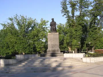 Vuk Karadžić Monument with a seated bronze figure holding a book on a tall stone pedestal