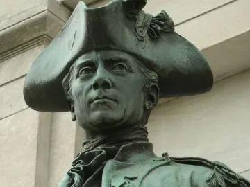 Close-up of the John Paul Jones Memorial bronze statue showing John Paul Jones in a tricorn hat and military coat.