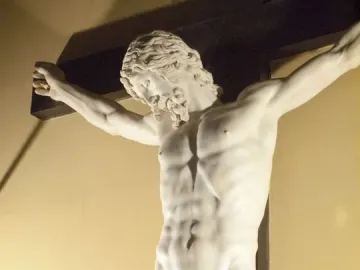 Cellini Crucifix showing a white marble Christ figure on a dark wooden cross