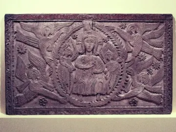 Relief panel from the Rachis Altar showing a seated central figure, two smaller figures, and surrounding winged haloed beings.