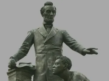 The Emancipation Memorial shows Abraham Lincoln standing beside a kneeling bare-chested man holding a broken chain.