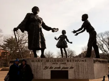 Mary McLeod Bethune Memorial bronze statue of Mary McLeod Bethune with two children reaching toward her.