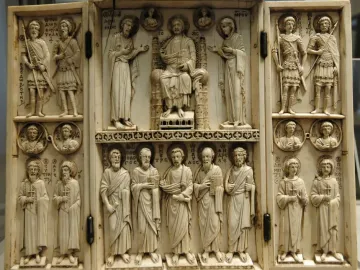 Harbaville Triptych with three carved ivory panels showing a central seated figure flanked by standing figures, busts in roundels, and inscriptions.