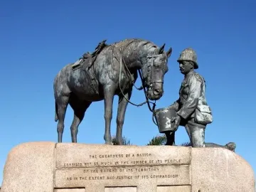 The Horse Memorial shows a saddled horse beside a kneeling soldier holding a bucket on a stone plinth with inscriptions.