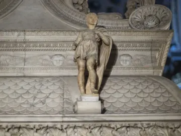 Marble statue of Saint Proculus standing on an ornate base within a larger monument.