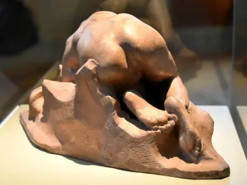 Danaid by Auguste Rodin, a terracotta sculpture of a nude female figure bent forward against a rock-like base.