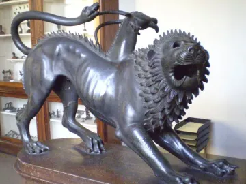 Chimera of Arezzo bronze sculpture showing a lion with a goat’s head on its back and a snake tail.