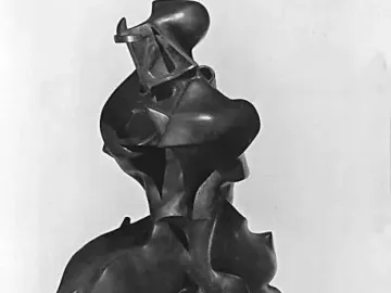 Unique Forms of Continuity in Space, a dark bronze-like sculpture of a striding figure with flowing, aerodynamic forms.
