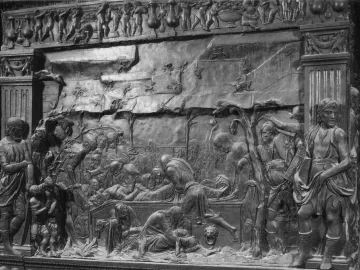 The Passion Pulpit relief showing a burial scene with robed figures beneath classical columns and a decorative frieze.