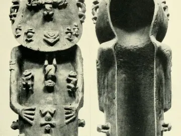 A standing wooden A\'a figure covered with many small carved humanoid figures, with a hollow cavity visible down the back.