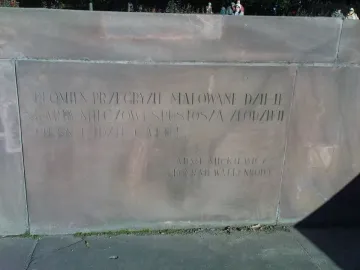 Close-up of the Chopin Monument base with an engraved Polish inscription.